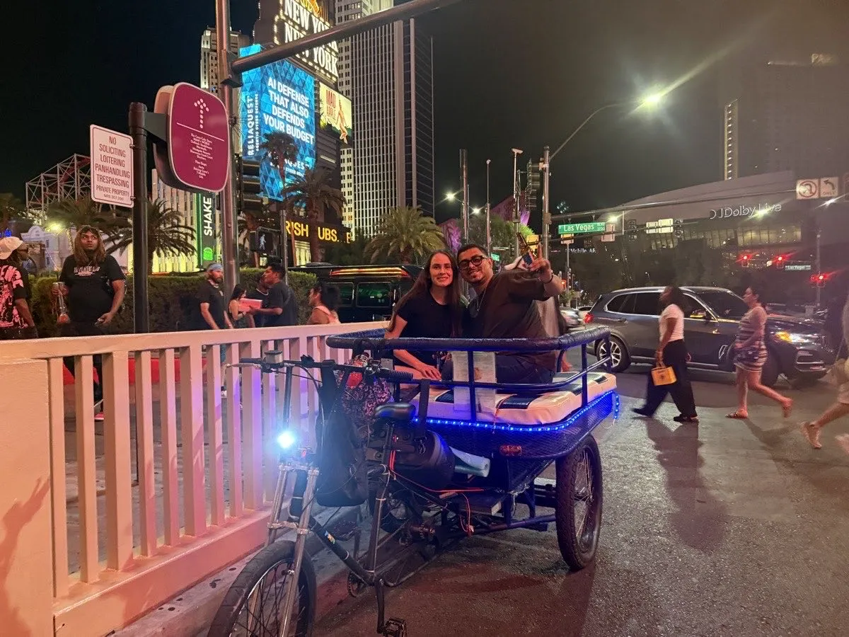 Vegas Bike Cab pedicab passing New York-New York on the Las Vegas Strip at night